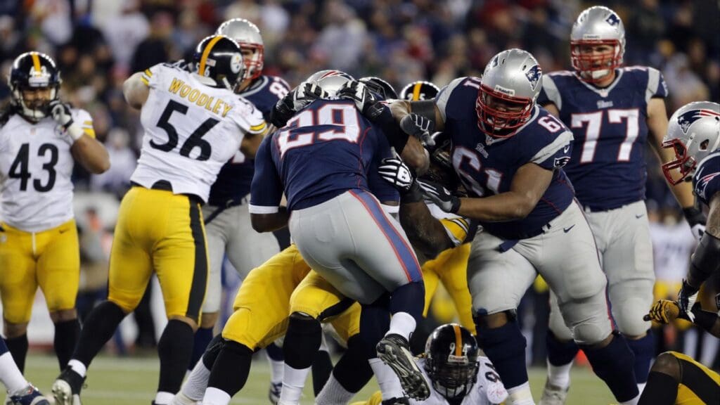 Nov 3, 2013; Foxborough, MA, USA; New England Patriots running back LeGarrette Blount (29) is helped into the end zone with a push from tackle Marcus Cannon (61) against the Pittsburgh Steelers in the second half at Gillette Stadium. The Patriots defeated the Steelers 55-31