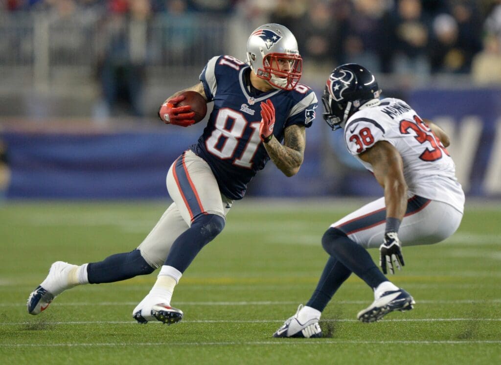 Jan 13, 2013; Foxboro, MA, USA; New England Patriots tight end Aaron Hernandez (81) is pursued by Houston Texans safety Daniel Manning (38) in the AFC Divisional Round playoff game at Gillette Stadium. The Patriots defeated the Texans 41-28.