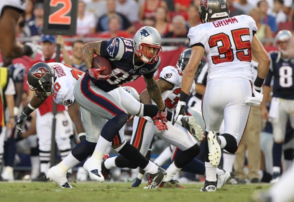 August 18, 2011; Tampa, FL, USA; New England Patriots tight end Aaron Hernandez (81) runs with the ball as Tampa Bay Buccaneers safety Cody Grimm (35) defends during the first quarter at Raymond James Stadium.