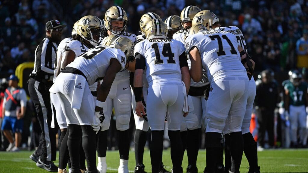 Jan 1, 2023; Philadelphia, Pennsylvania, USA; New Orleans Saints quarterback Andy Dalton (14) in the huddle with his team against the Philadelphia Eagles at Lincoln Financial Field.