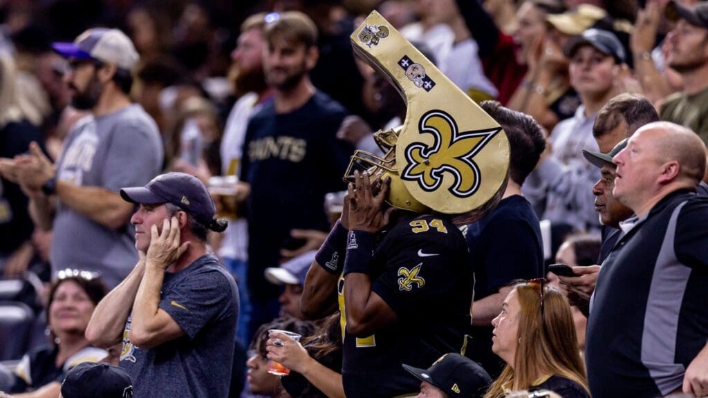 Nov 17, 2024; New Orleans, Louisiana, USA; New Orleans Saints fan holds his ears as superfan Whistle Monster whistles against the Cleveland Browns during the second half at Caesars Superdome.