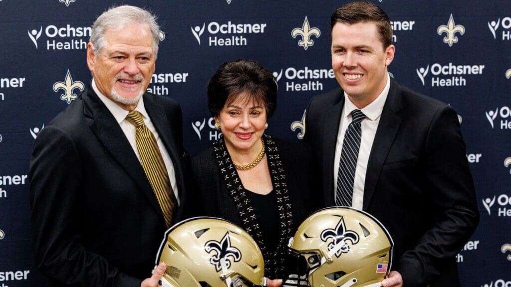Feb 13, 2025; New Orleans, LA, USA; New Orleans Saints owner Gayle Benson and general manager Mickey Loomis pose with the new head coach Kellen Moore at Ochsner Sports Performance Center.