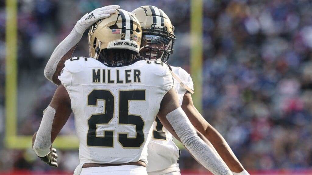 Dec 8, 2024; East Rutherford, New Jersey, USA; New Orleans Saints running back Kendre Miller (25) celebrates with running back Alvin Kamara (41) after a rushing touchdown during the first half against the New York Giants at MetLife Stadium.