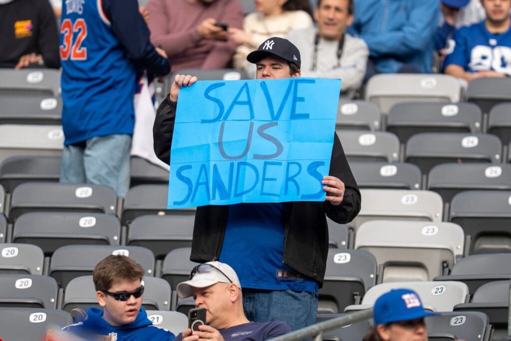 A New York Giants fan holds a sign saying “Save Us Sanders” during a game between New York Giants and Indianapolis Colts at MetLife Stadium on Sunday, Dec. 29, 2024.