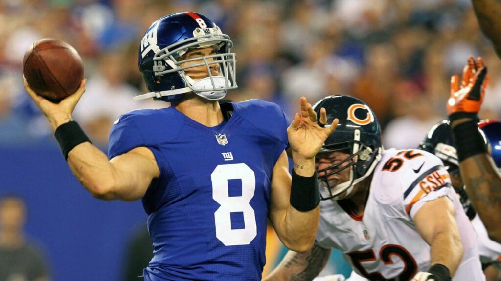 August 24, 2012; East Rutherford, NJ, USA; New York Giants quarterback David Carr (8) is hit as he throws by Chicago Bears linebacker Blake Costanzo (52) during the third quarter of a preseason game at MetLife Stadium