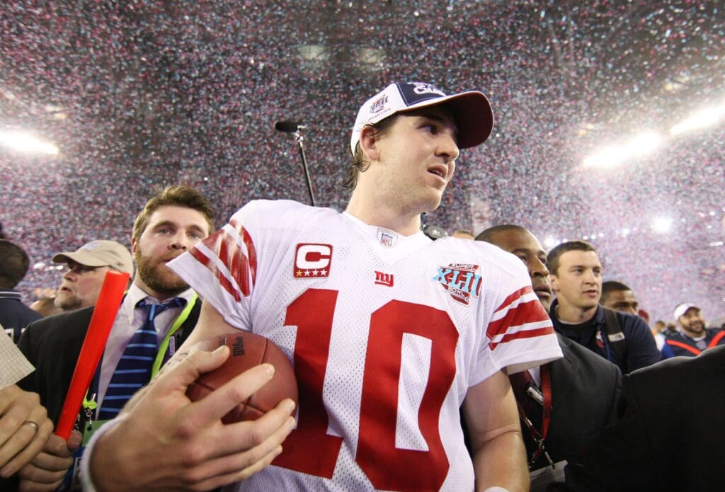 Feb 3, 2008; Glendale, AZ, USA; New York Giants quarterback Eli Manning (10) holds a game-ball after defeating the New England Patriots in Super Bowl XLII at the University of Phoenix Stadium. The New York Giants defeated the New England Patriots 17-14.