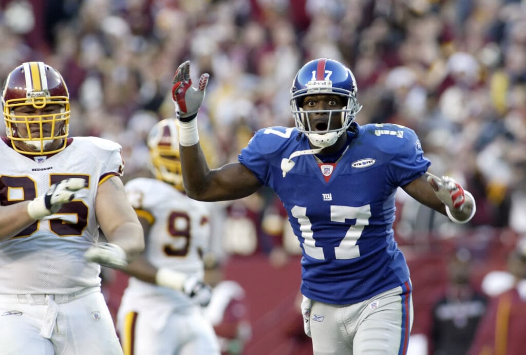 Dec 24, 2005; Landover, MD, USA; New York Giants wide receiver Plaxico Burress looks for a pass interference call as Washington Redskins defensive lineman Joe Salave'a celebrates during 2nd half action of the teams' matchup at FedEx Field.