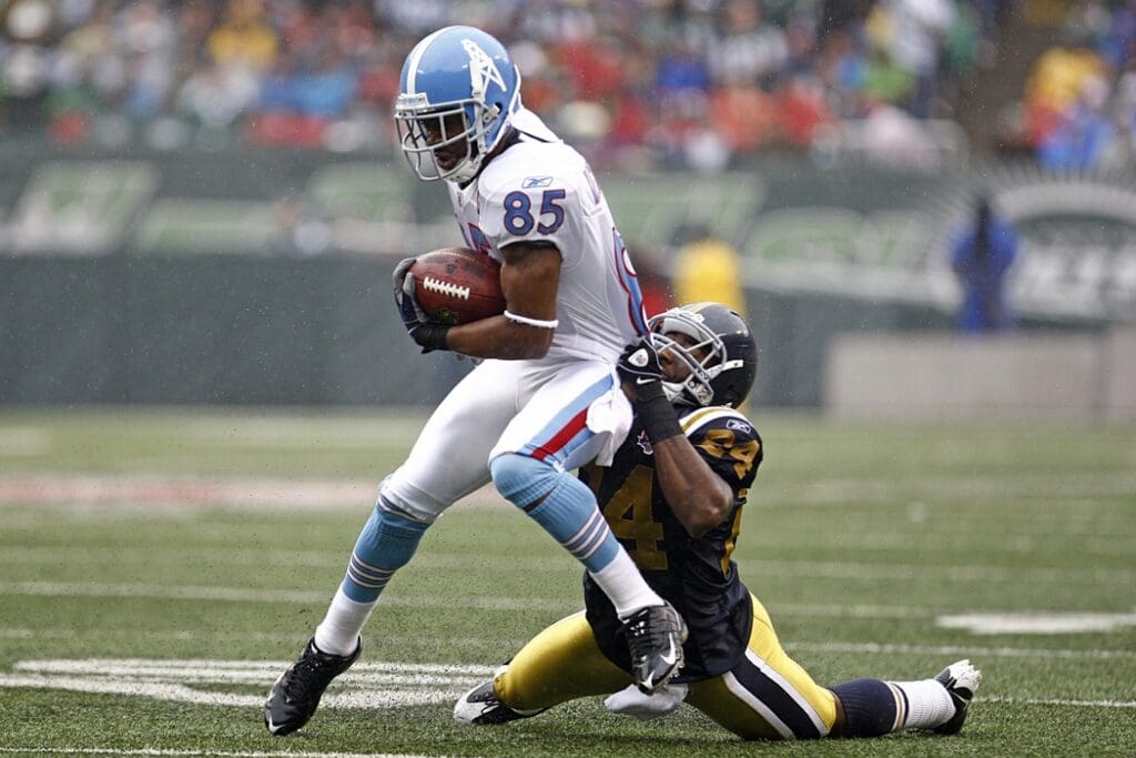 Sept 27, 2009; East Rutherford, NJ, USA; Tennessee Titans wide receiver Nate Washington (85) is tackled by New York Jets cornerback Darrelle Revis (24) during the first half at Giants Stadium.