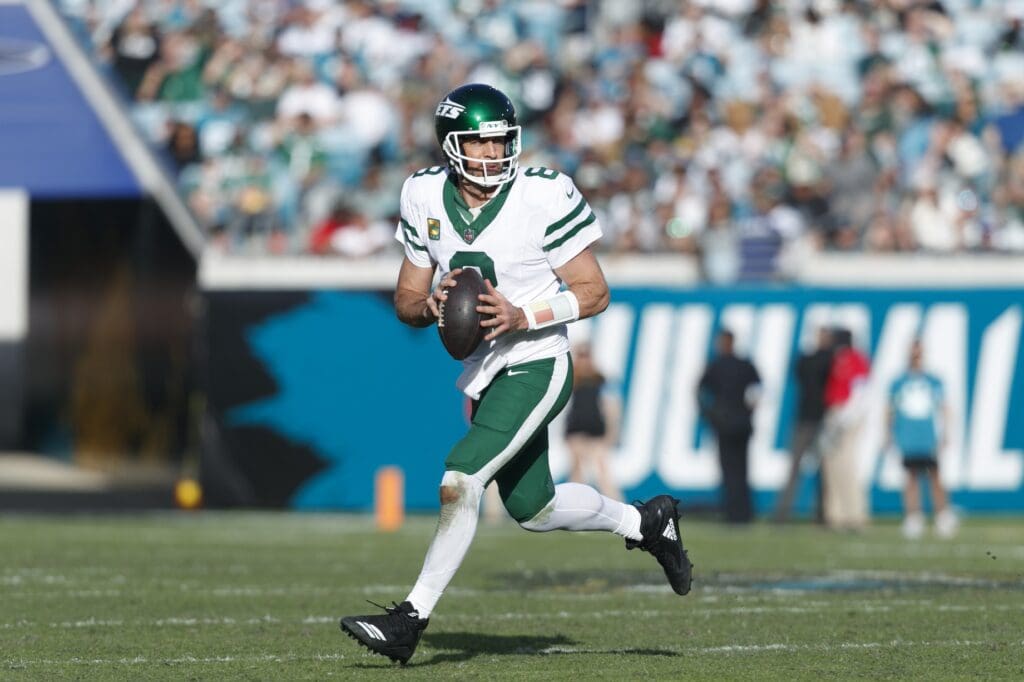 Dec 15, 2024; Jacksonville, Florida, USA; New York Jets quarterback Aaron Rodgers (8) looks for a pass against the Jacksonville Jaguars during the fourth quarter at EverBank Stadium.