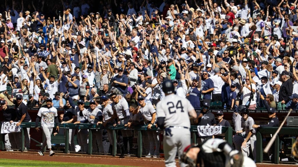 Apr 3, 2024; Phoenix, Arizona, USA; New York Yankees fans in the crowd celebrate as outfielder Alex Verdugo rounds the bases after hitting a two run home run in the tenth inning against the Arizona Diamondbacks at Chase Field.