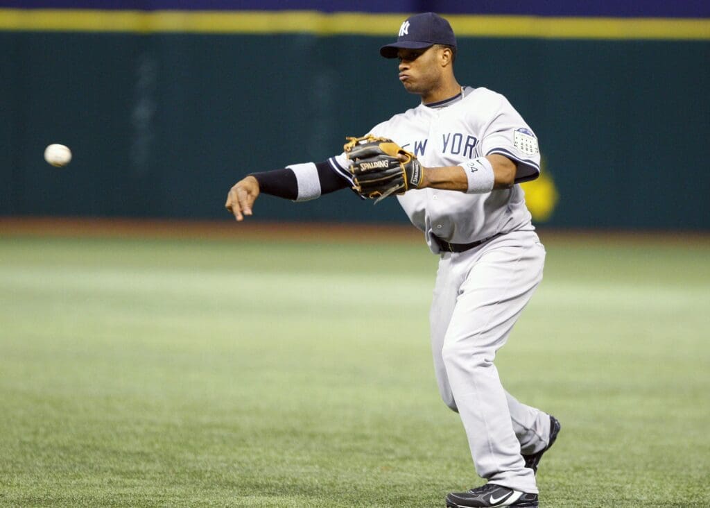 April 15, 2008; St. Petersburg, FL, USA; New York Yankees second baseman Robinson Cano (24) throws the ball to 1st for an out in the 9th inning against the Tampa Bay Rays at Tropicana Field. He is wearing jersey number 42 to honor former major leaguer Jackie Robinson.