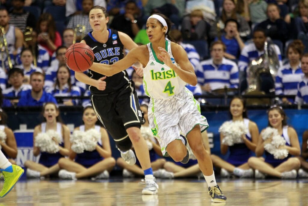 Apr 2, 2013; Norfolk, VA, USA; Notre Dame Fighting Irish guard Skylar Diggins (4) dribbles the ball as Duke Blue Devils guard/forward Haley Peters (33) chases during the second half in the 2013 NCAA womens basketball tournament at Ted Constant Convocation Center. The Fighting Irish won 87-76.