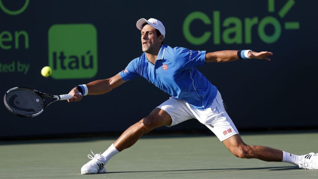 Mar 31, 2015; Key Biscayne, FL, USA; Novak Djokovic reaches for a forehand against Alexandr Dolgopolov (not pictured) on day nine of the Miami Open at Crandon Park Tennis Center. Djokovic won 6-7 (3), 7-5, 6-0.