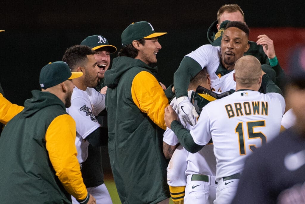 Apr 4, 2023; Oakland, California, USA; Oakland Athletics second baseman Tony Kemp (5) celebrates with team mates after hitting a game winning single during the ninth inning of the game against the Cleveland Guardians at RingCentral Coliseum.