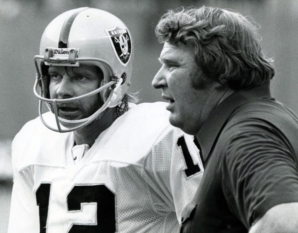 Oakland Raiders head coach John Madden on the sidelines with quarterback Ken Stabler (12).