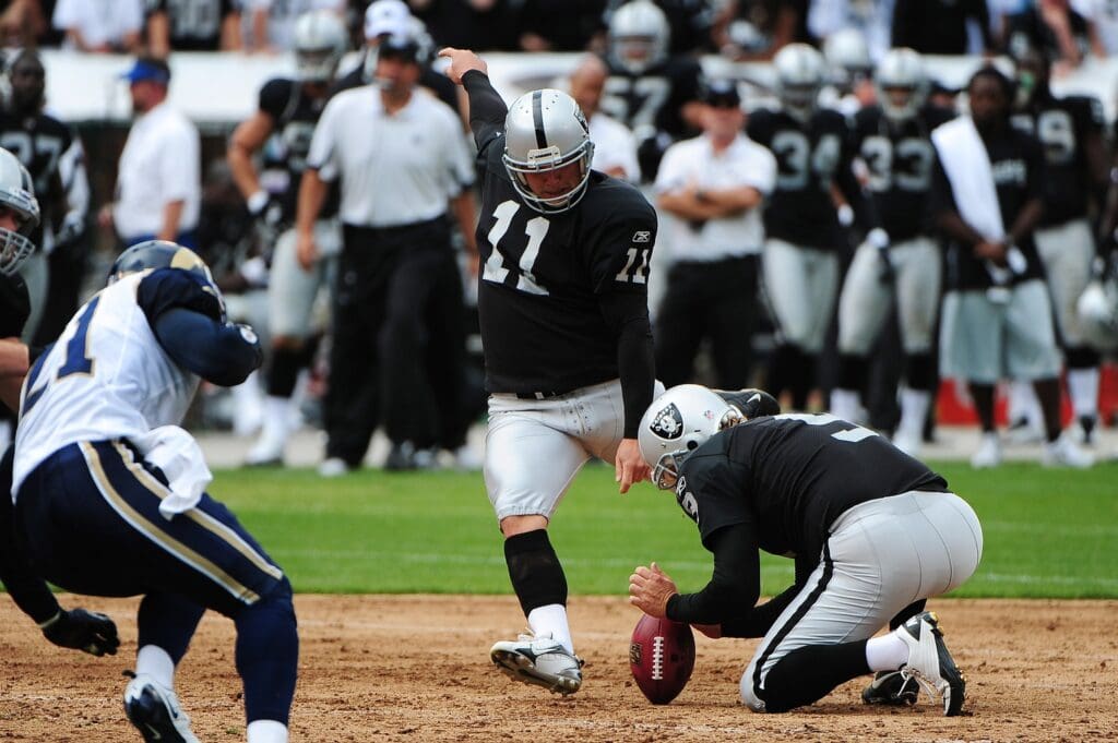 September 19, 2010; Oakland, CA, USA; Oakland Raiders place kicker Sebastian Janikowski (11) attempts a field goal during the first quarter against the St. Louis Rams at Oakland-Alameda County Coliseum.