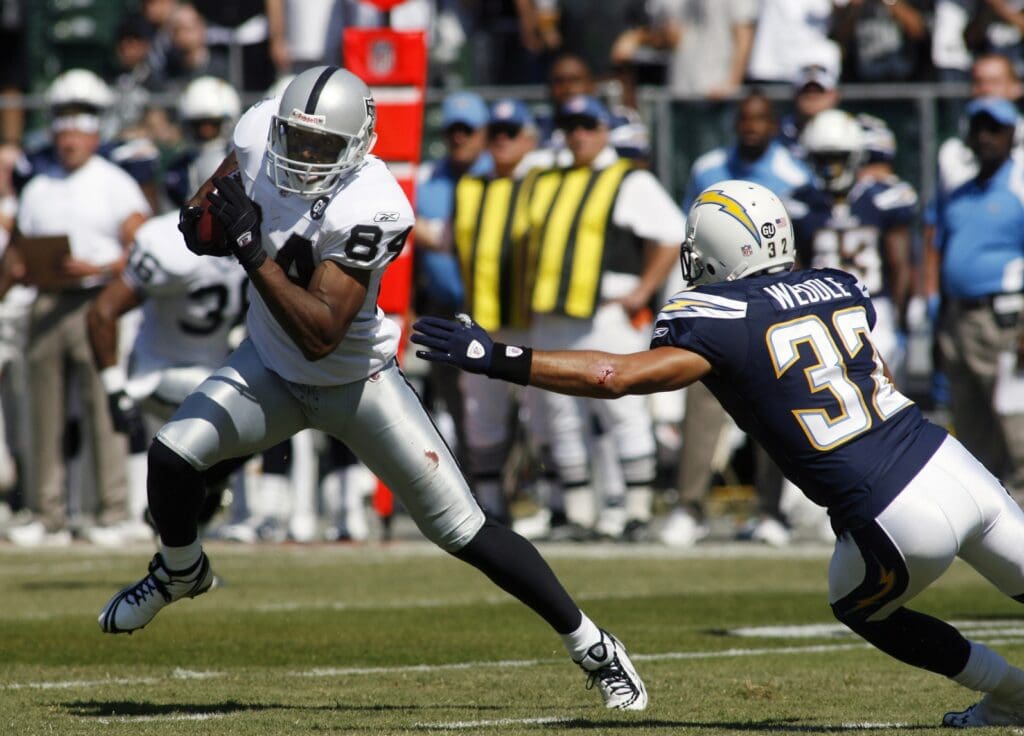 Sept 28, 2008; Oakland, CA, USA; Oakland Raiders wide receiver Javon Walker (84) eludes San Diego Chargers strong safety Eric Weddle (32) during the first quarter at McAfee Coliseum in Oakland, CA.