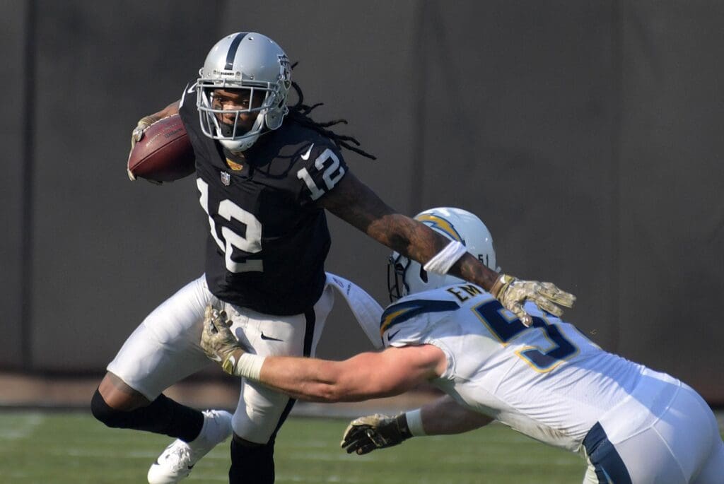Nov 11, 2018; Oakland, CA, USA; Oakland Raiders wide receiver Martavis Bryant (12) is defended by Los Angeles Chargers outside linebacker Kyle Emanuel (51) in the first quarterat Oakland-Alameda County Coliseum.