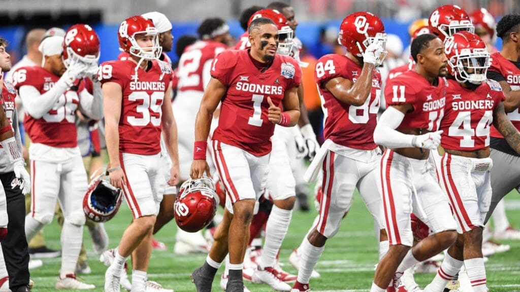 Dec 28, 2019; Atlanta, Georgia, USA; Oklahoma Sooners quarterback Jalen Hurts (1) runs onto the field with his teammates before the 2019 Peach Bowl college football playoff semifinal game between the LSU Tigers and the Oklahoma Sooners at Mercedes-Benz Stadium.