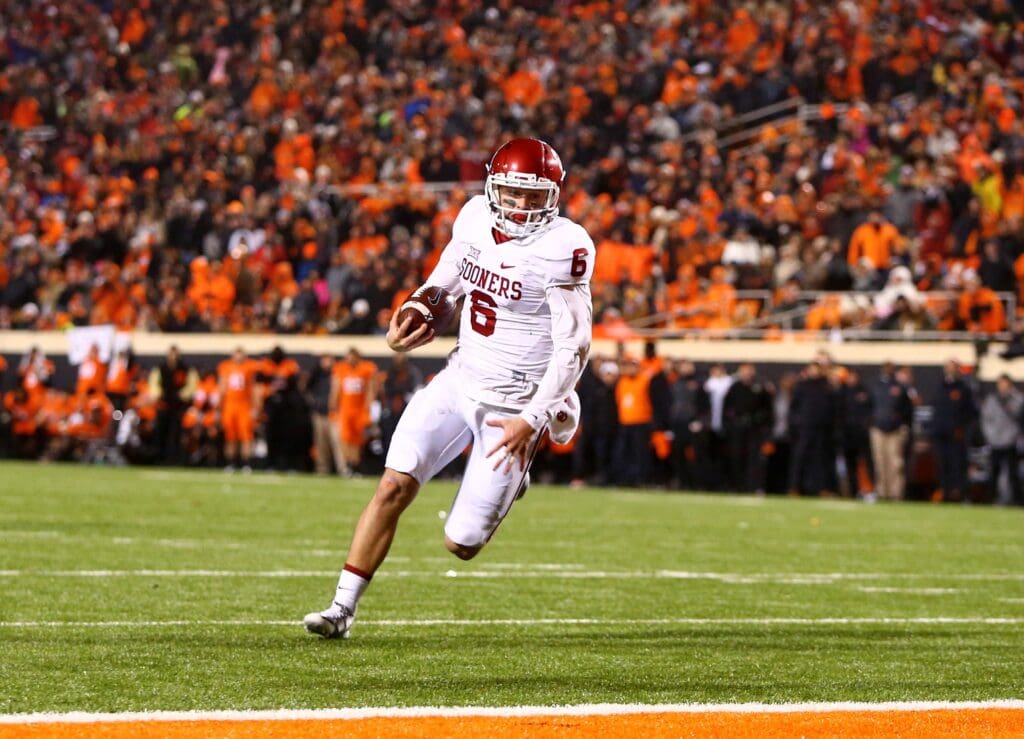 Nov 28, 2015; Stillwater, OK, USA; Oklahoma Sooners quarterback Baker Mayfield (6) runs the ball for a touchdown in the second half against the Oklahoma State Cowboys at Boone Pickens Stadium. The Sooners defeated the Cowboys 58-23.