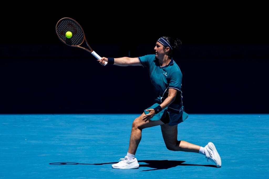Jan 18, 2025; Melbourne, Victoria, Australia; Ons Jabeur of Tunisia hits a forehand during her match against Emma Navarro of United States of America in the third round of the women's singles at the 2025 Australian Open at Melbourne Park.