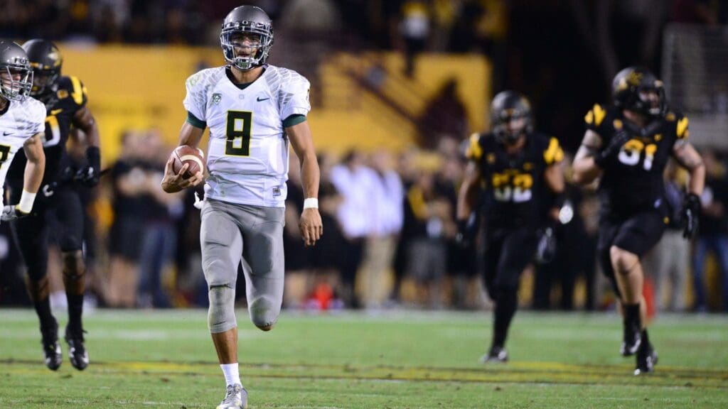 Oct. 18, 2012; Tempe, AZ, USA; Oregon Ducks quarterback (8) Marcus Mariota runs for a first half touchdown against the Arizona State Sun Devils at Sun Devil Stadium. Oregon defeated Arizona State 43-21.