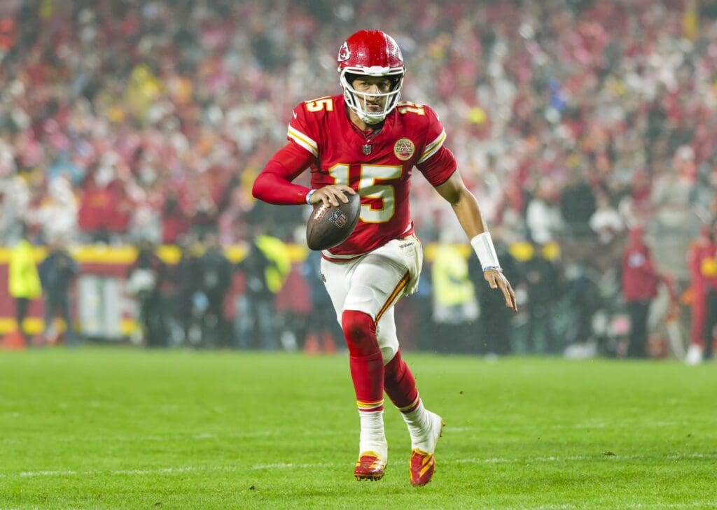 Nov 4, 2024; Kansas City, Missouri, USA; Kansas City Chiefs quarterback Patrick Mahomes (15) rolls out to pass during the second half against the Tampa Bay Buccaneers at GEHA Field at Arrowhead Stadium.