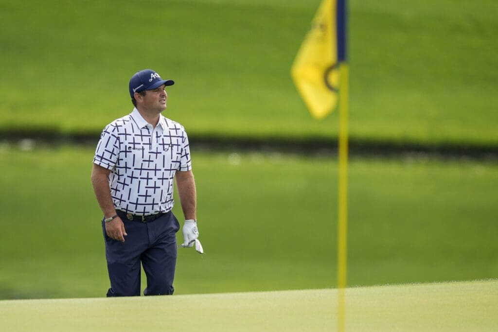 May 14, 2025; Charlotte, North Carolina, USA; Patrick Reed watches his ball on the 16th green during a practice round for the PGA Championship golf tournament at Quail Hollow.