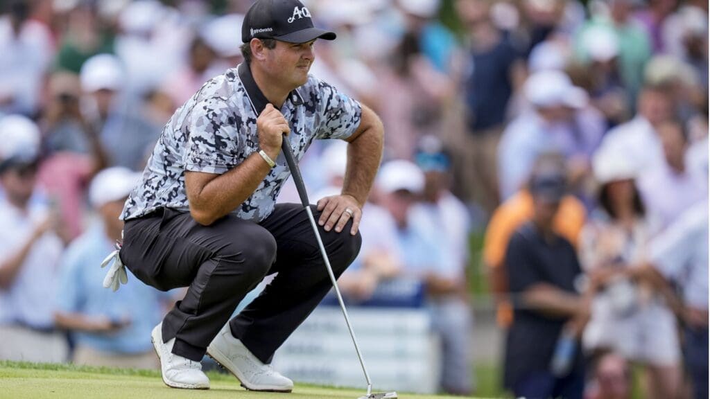 May 15, 2025; Charlotte, North Carolina, USA; Patrick Reed lines up his putt during the first round of the PGA Championship golf tournament at Quail Hollow.