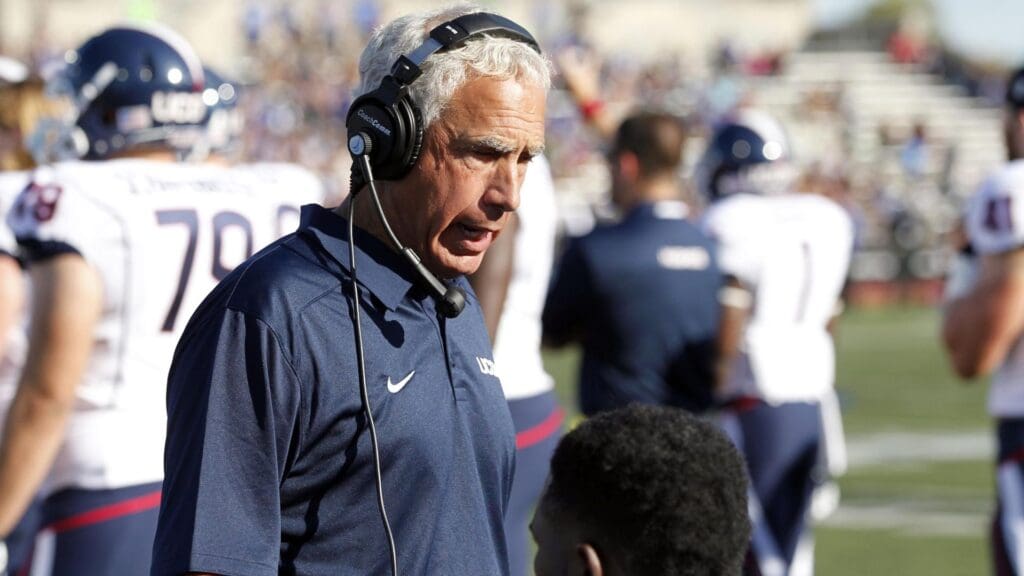 Sep 28, 2013; Buffalo, NY, USA; Connecticut Huskies head coach Paul Pasqualoni talks to the defense on the bench during the first half against the Buffalo Bulls at University of Buffalo Stadium.