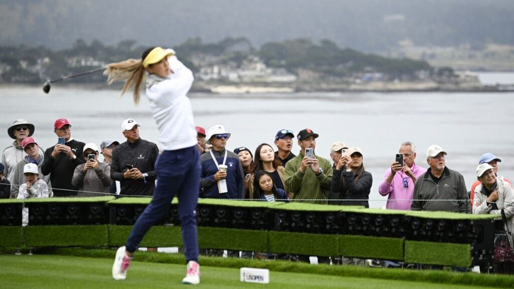 Jul 6, 2023; Pebble Beach, California, USA; Fans watch as Michelle Wie tees off on the 14th hole during the first round of the U.S. Women's Open golf tournament at Pebble Beach Golf Links