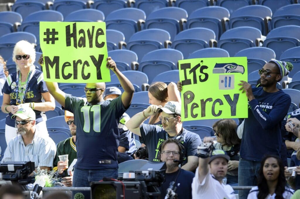 Sep 4, 2014; Seattle, WA, USA; Fans hold up signs for Seattle Seahawks wide receiver Percy Harvin (not pictured) during the pre game warm up prior to the game against the Green Bay Packers at CenturyLink Field.