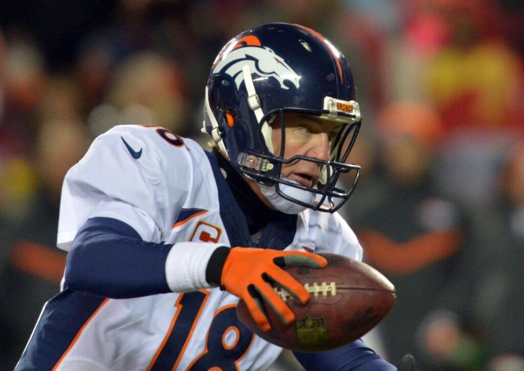 Nov 30, 2014; Kansas City, MO, USA; Denver Broncos quarterback Peyton Manning (18) slips while dropping back during the second half against the Kansas City Chiefs at Arrowhead Stadium. The Broncos won 29-16