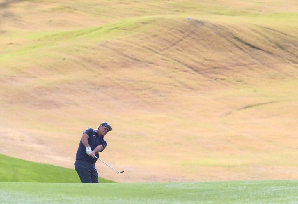 Phil Mickelson takes a shot from off the 11th green landing inches from the cup on the Pete Dye Stadium course during the third round of The American Express at PGA West in La Quinta, Calif., Saturday, Jan. 22, 2022. Syndication Desert Sun