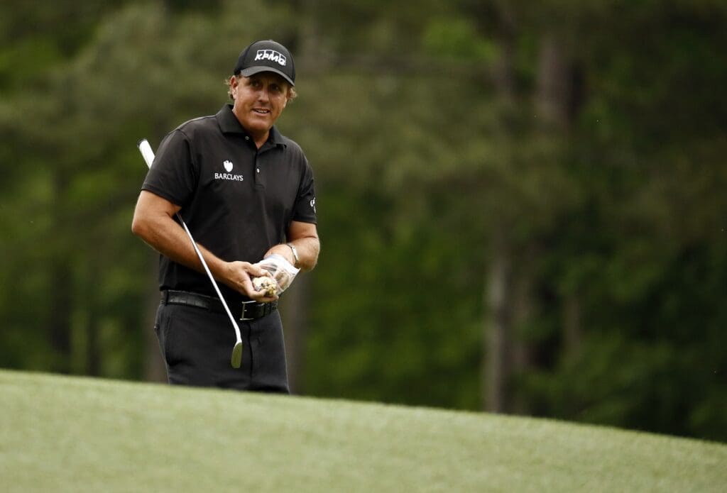 Phil Mickelson walks off the 12th tee during the final round of The Masters golf tournament at Augusta National Golf Club.