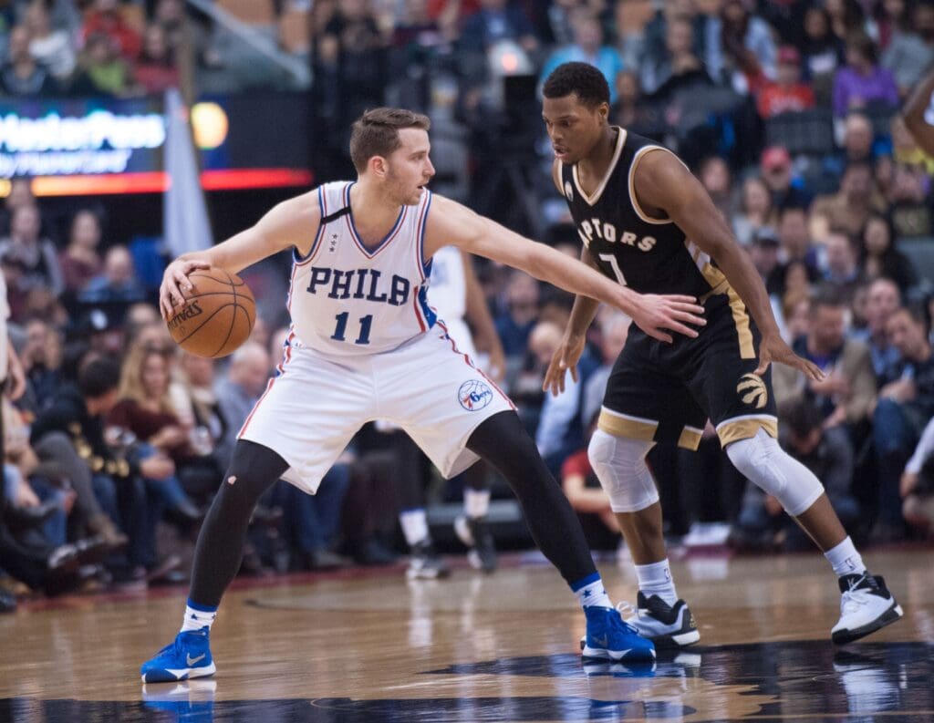 Dec 13, 2015; Toronto, Ontario, CAN; Philadelphia 76ers guard Nik Stauskas (11) dribbles against Toronto Raptors guard Kyle Lowry (7) in the third quarter at Air Canada Centre. Raptors beat 76ers 96 - 76.