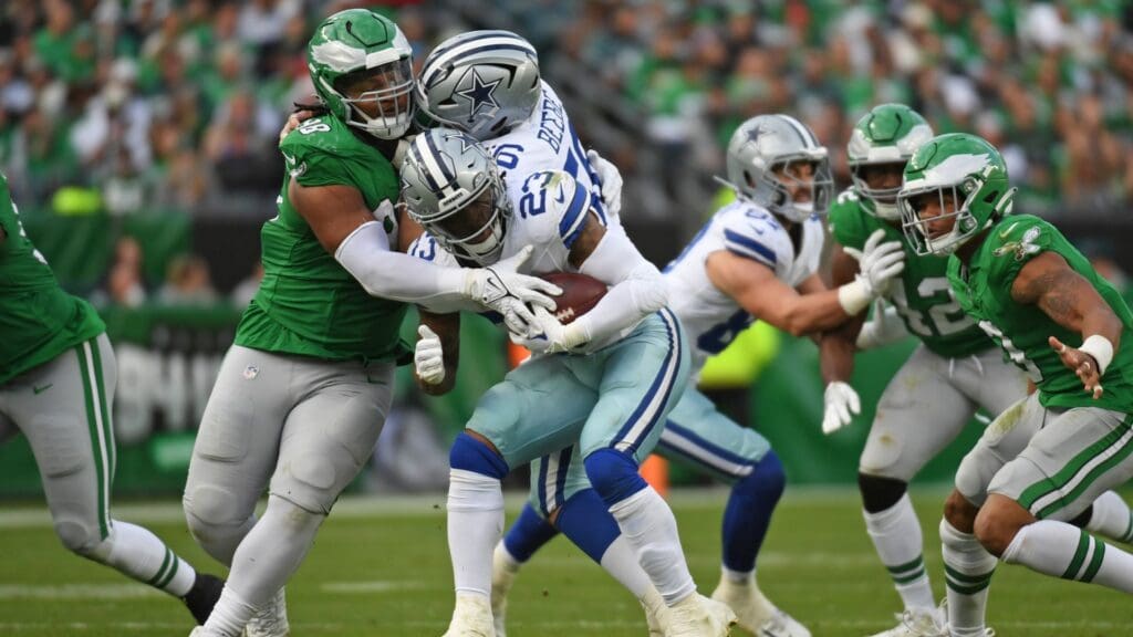 Dec 29, 2024; Philadelphia, Pennsylvania, USA; Philadelphia Eagles defensive tackle Jalen Carter (98) triers to stop Dallas Cowboys running back Rico Dowdle (23) during the third quarter at Lincoln Financial Field.
