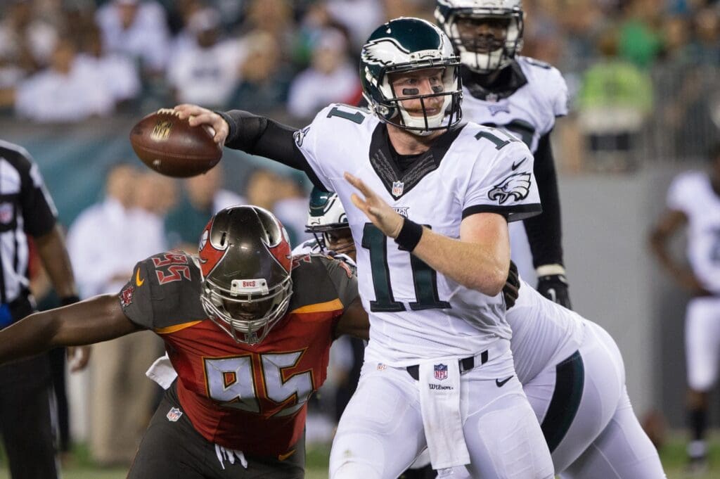 Aug 11, 2016; Philadelphia, PA, USA; Philadelphia Eagles quarterback Carson Wentz (11) passes the football defended by Tampa Bay Buccaneers defensive end Howard Jones (95) during the second half at Lincoln Financial Field. The Philadelphia Eagles won 17-9.