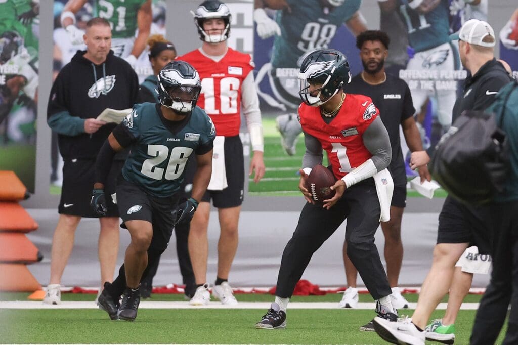 May 28, 2025; Philadelphia, PA, USA; Philadelphia Eagles quarterback Jalen Hurts (1) hands off to running back Saquon Barkley (26) during OTAs at NovaCare Complex.