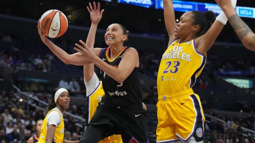 Sep 17, 2024; Los Angeles, California, USA; Phoenix Mercury guard Diana Taurasi (3) shoots the ball against LA Sparks forward Dearica Hamby (5) and forward Azura Stevens (23) in the first half at Crypto.com Arena.