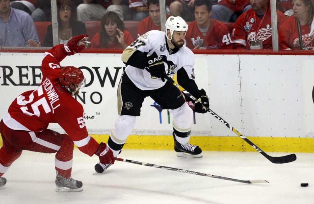 Jun 2, 2008; Detroit, MI, USA; Pittsburgh Penguins left wing Jarkko Ruutu (37) prepares to pass the puck away from Detroit Red Wings defenseman Niklas Kronwall (55) during the first overtime period of game five of the Stanley Cup finals at Joe Louis Arena.