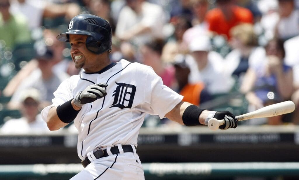 June 8, 2008; Detroit, MI, USA; Detroit Tigers second baseman Placido Polanco (14) singles to left field scoring Detroit Tigers catcher Ivan Rodriguez and Detroit Tigers left fielder Brent Clevlen (not in photo) in the fourth inning against the Cleveland Indians.