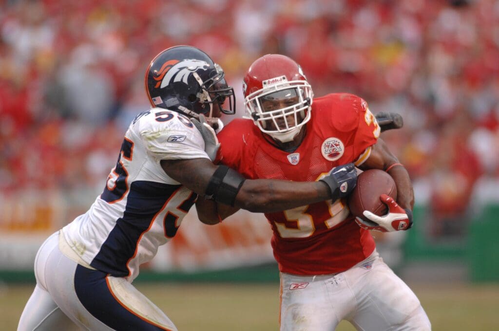 November 11, 2007; Kansas City, MO, USA; Kansas City Chiefs running back Priest Holmes (31) is tacked by Denver Broncos linebacker D.J. Williams (55) in the third quarter in the Chiefs 27-11 loss to the Broncos at Arrowhead Stadium.