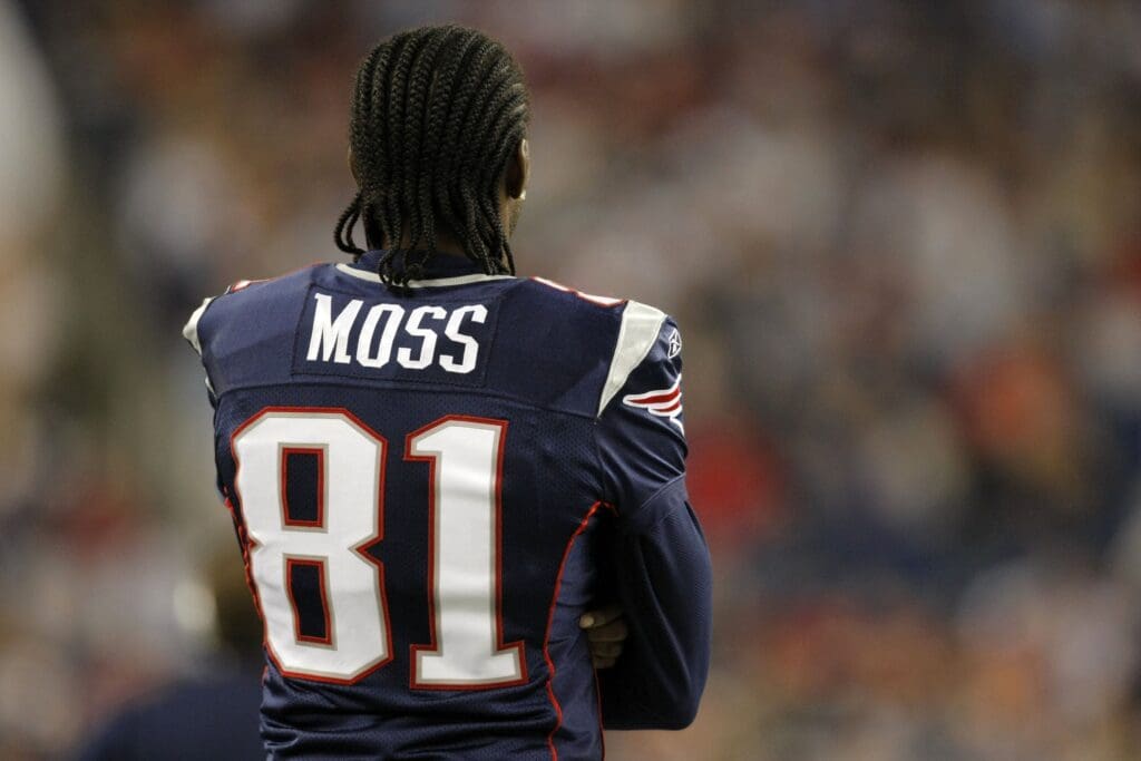 Sep 3, 2009; Foxborough, MA, USA; New England Patriots wide receiver Randy Moss (81) watches from the sideline as the Patriots take on the New York Giants during the third quarter at Gillette Stadium. The Patriots defeated the Giants 38-27.