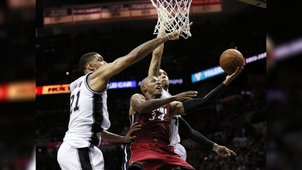 Jun 5, 2014; San Antonio, TX, USA; Miami Heat guard Ray Allen (34) shoots the ball against San Antonio Spurs forward Tim Duncan (21) and guard Danny Green (4) during the fourth quarter in game one of the 2014 NBA Finals at AT&T Center.