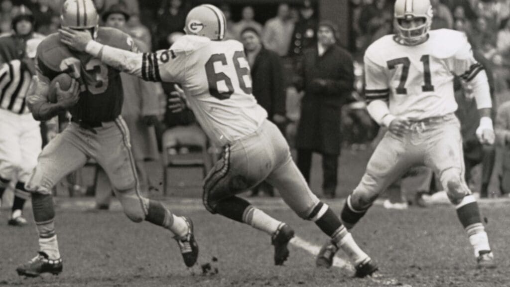 Oct 17, 1965; Detroit, MI, USA; FILE PHOTO; Green Bay Packers linebacker Ray Nitschke (66) with defensive tackle Lloyd Voss (71) tackles Detroit Lions running back Tom Watkins (23) at Tiger Stadium. The Packers beat the Lions 31-7.
