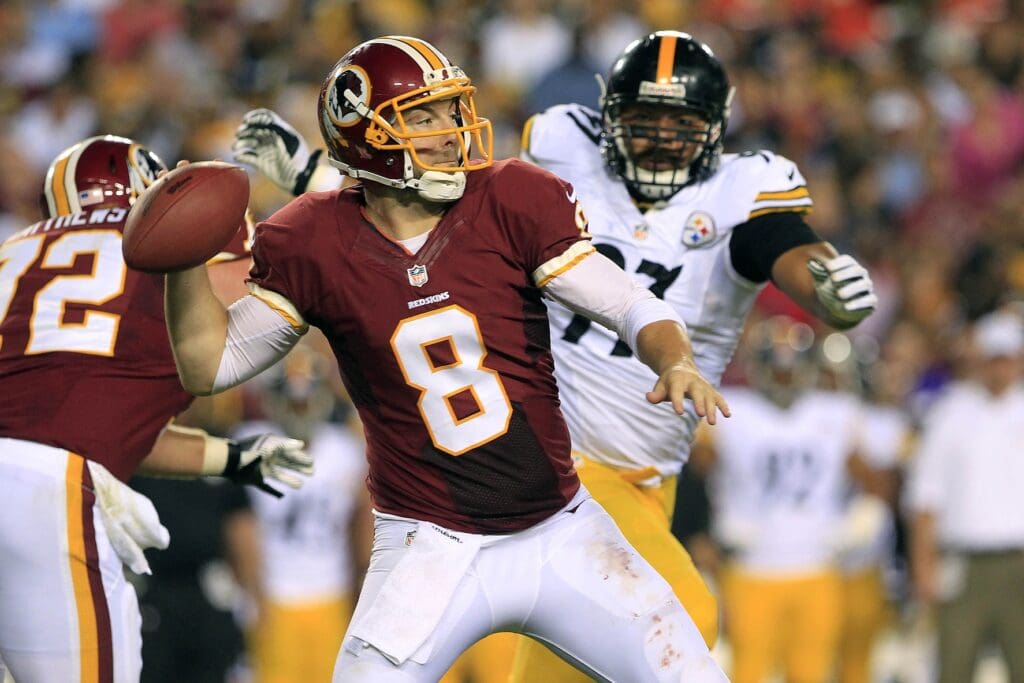 Aug 19, 2013; Landover, MD, USA; Washington Redskins quarterback Rex Grossman (8) throws the ball as Pittsburgh Steelers defensive end Cameron Heyward (97) chases in the third quarter at FedEx Field. The Redskins won 24-13.