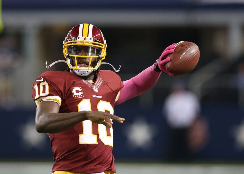 Oct 13, 2013; Arlington, TX, USA; Washington Redskins quarterback Robert Griffin III (10) throws left handed prior to the game against the Dallas Cowboys at AT&T Stadium.
