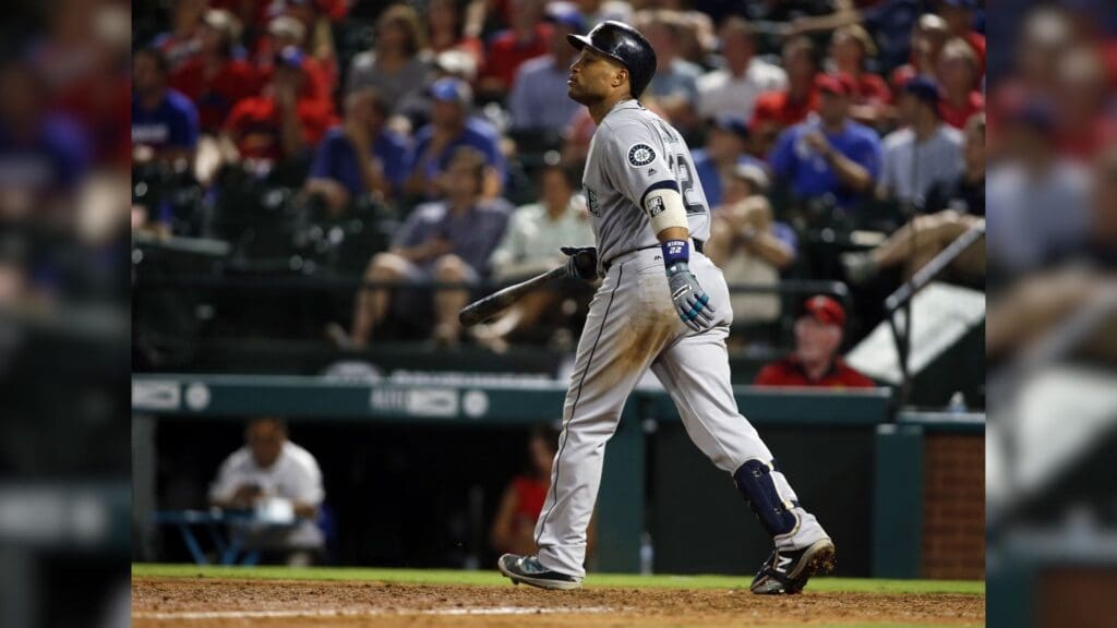 Aug 30, 2016; Arlington, TX, USA; Seattle Mariners second baseman Robinson Cano (22) hits a sacrifice fly to drive in a run in the eighth inning against the Texas Rangers at Globe Life Park in Arlington. Texas won 8-7.
