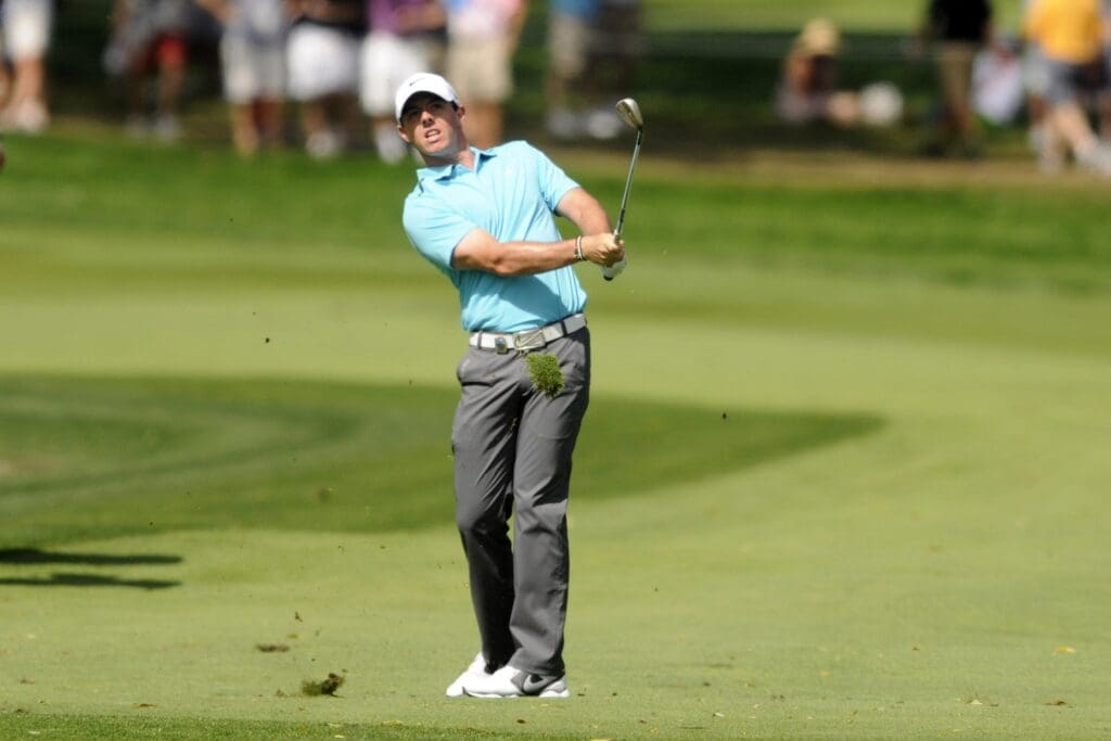 Aug 11, 2013; Rochester, NY, USA; Rory McIlroy hits his approach shot after a drop on the 5th hole during the final round of the 95th PGA Championship at Oak Hill Country Club..
